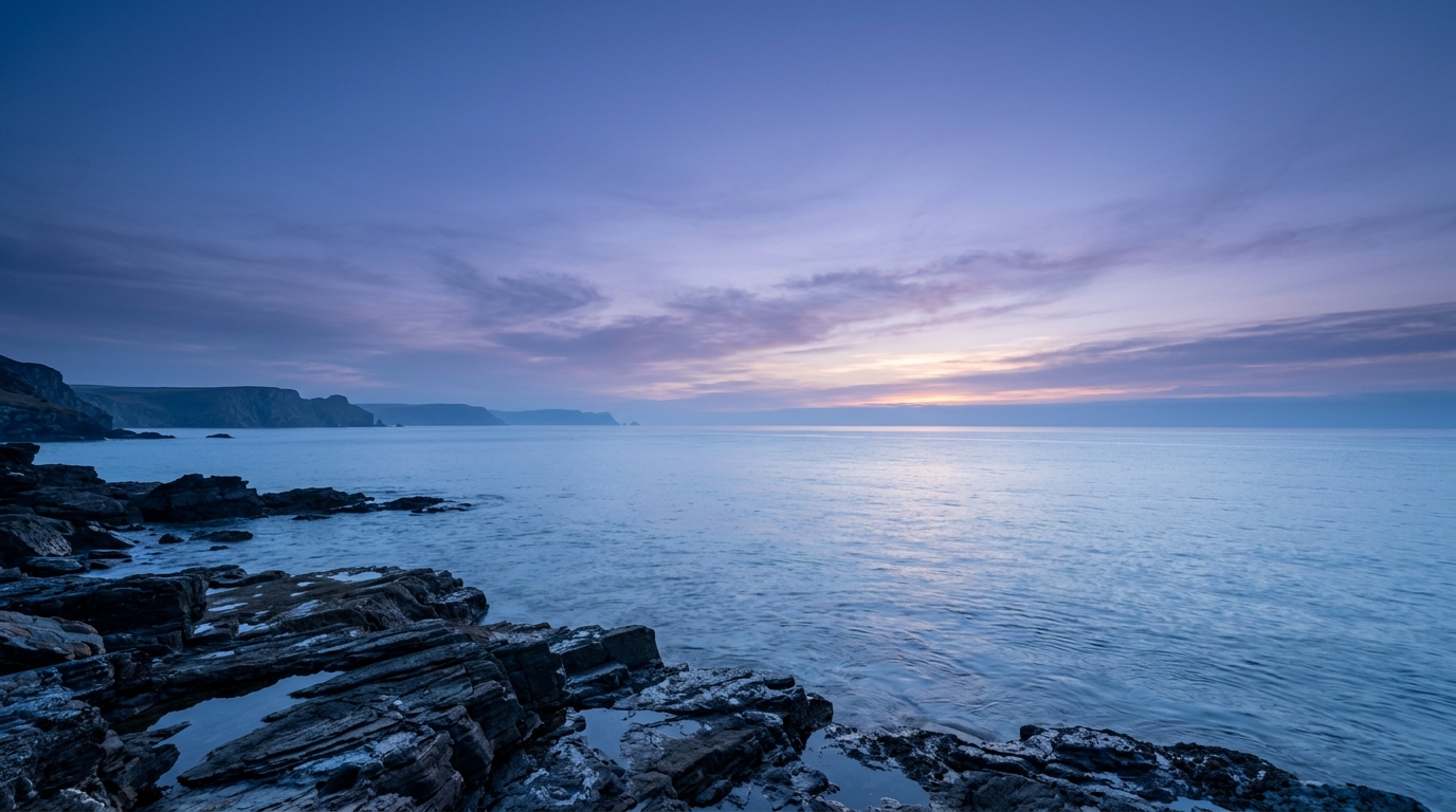 Photorealistic photo of sunset over the sea, wide shot with open space at the top for text, cool blue tones, quiet atmosphere, 16:9 aspect ratio